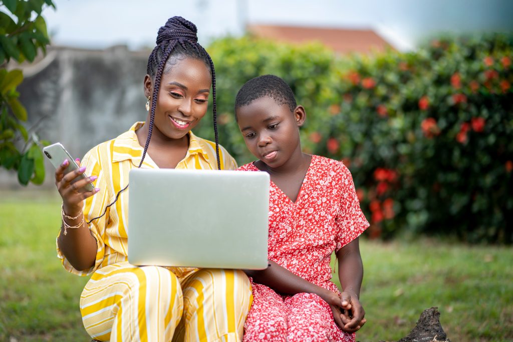 image of african lady and a kid with smart phone and laptop